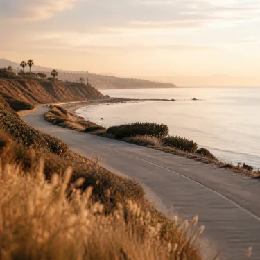 Late afternoon light over calm water and a quiet path in Newport Beach, the kind of walk that suits the hour after a massage.