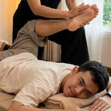 Therapist guiding a client through an assisted hamstring stretch